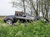 a beatyfull car behind the flowers 